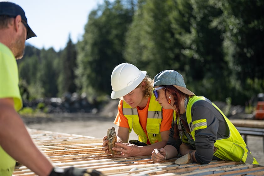 Workers examining mineral ore sample