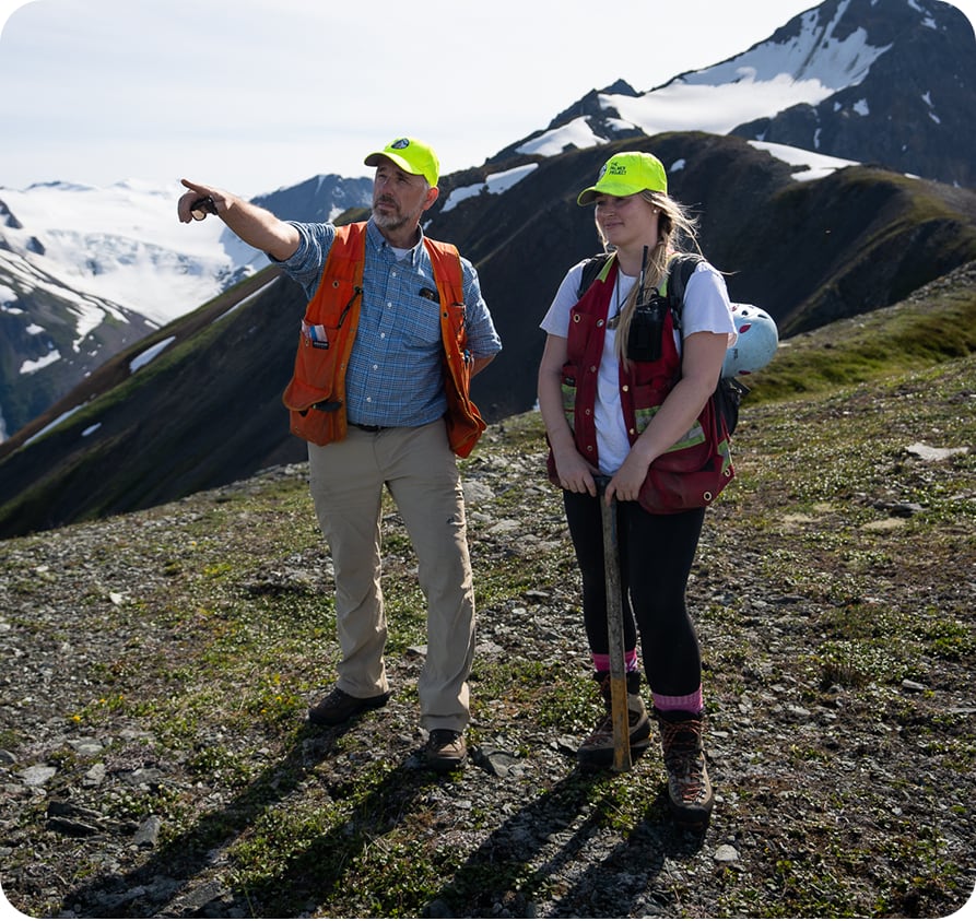Man pointing to something on a mountain top