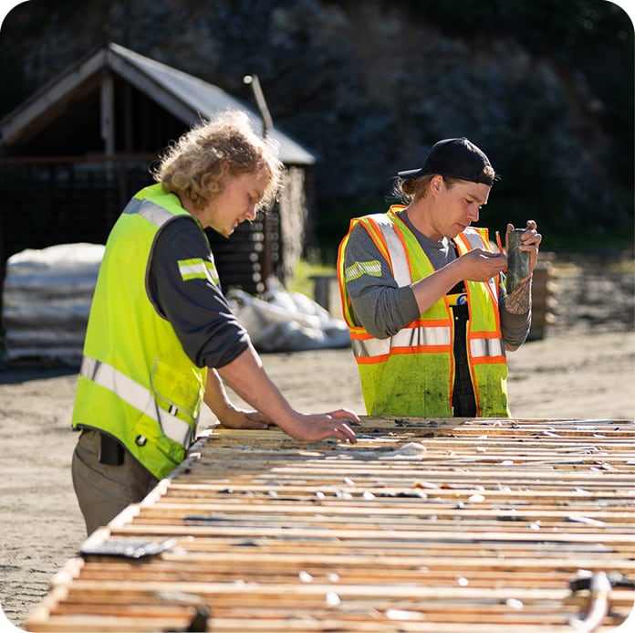 Workers looking at mineral ore
